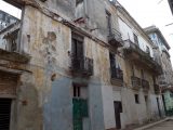 A decaying building with no roof, but still inhabited